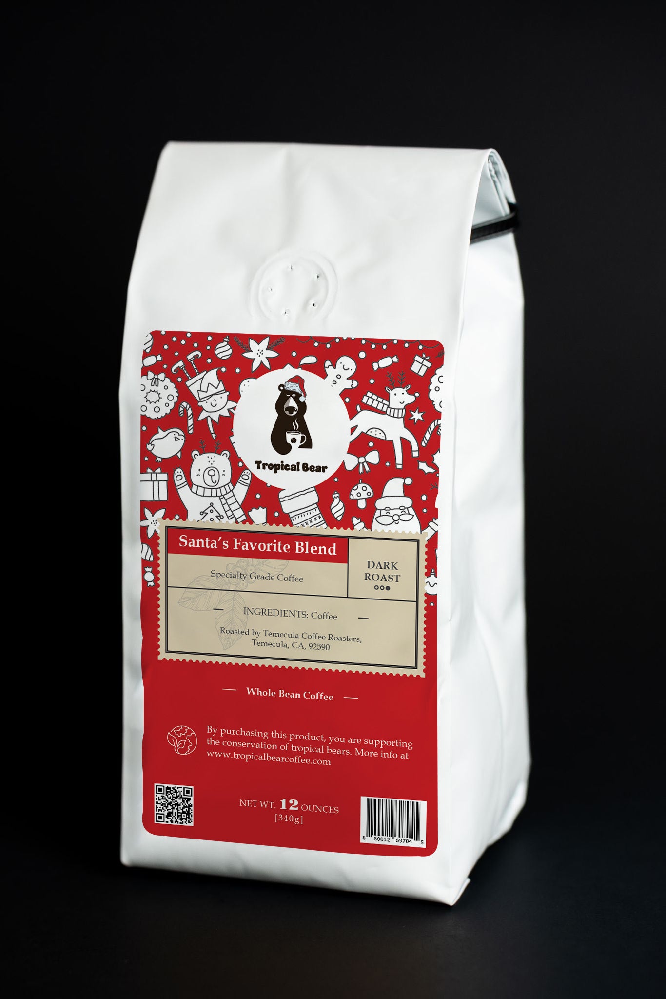 The bag of Tropical Bear Santa's Favorite Blend Specialty Grade Coffee, dark roast, whole bean, or ground good coffee.
