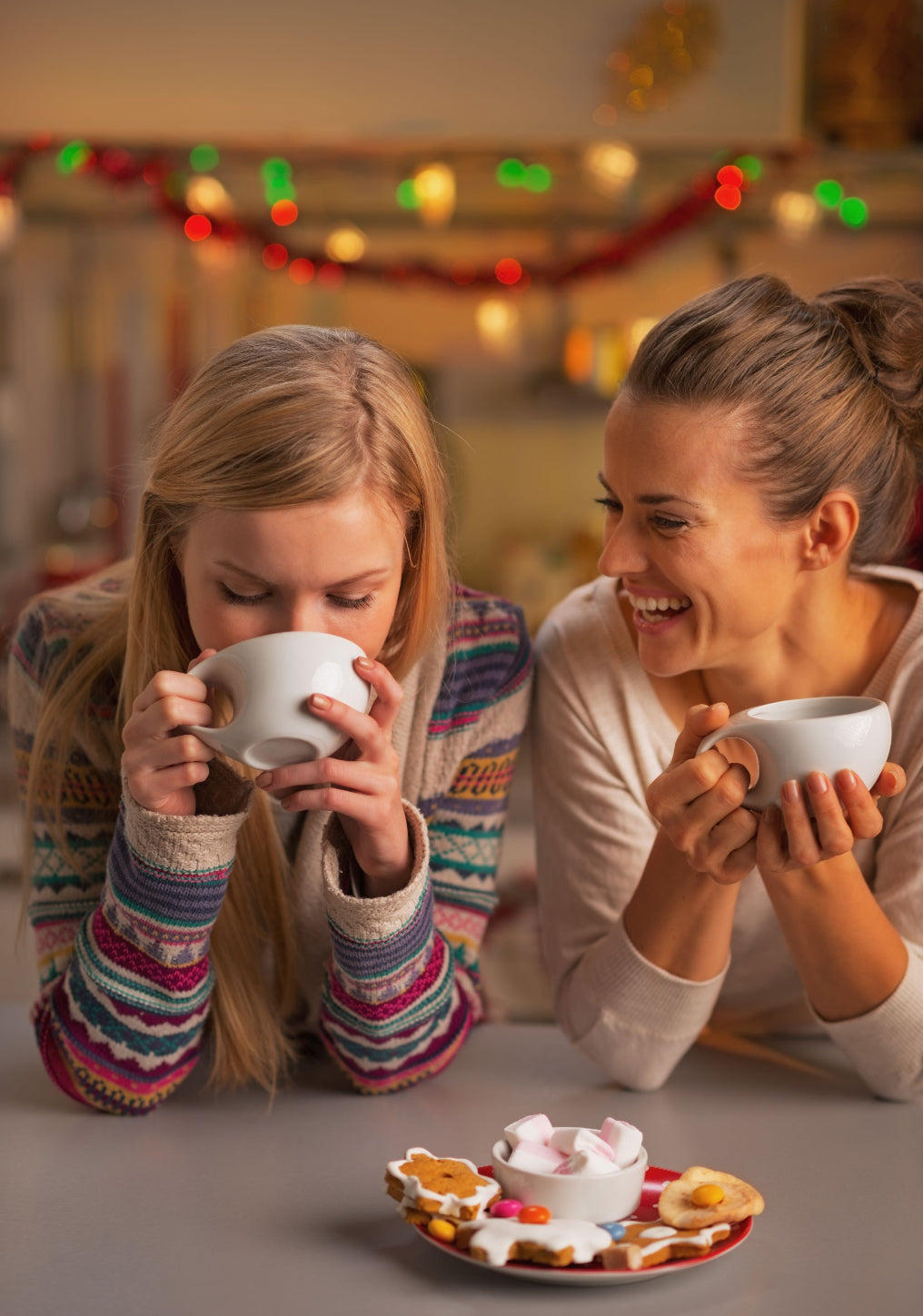 Ladies smiling at each other while drinking a cup of Tropical Bear Santa's Favorite Blend Specialty Coffee. Good coffee.