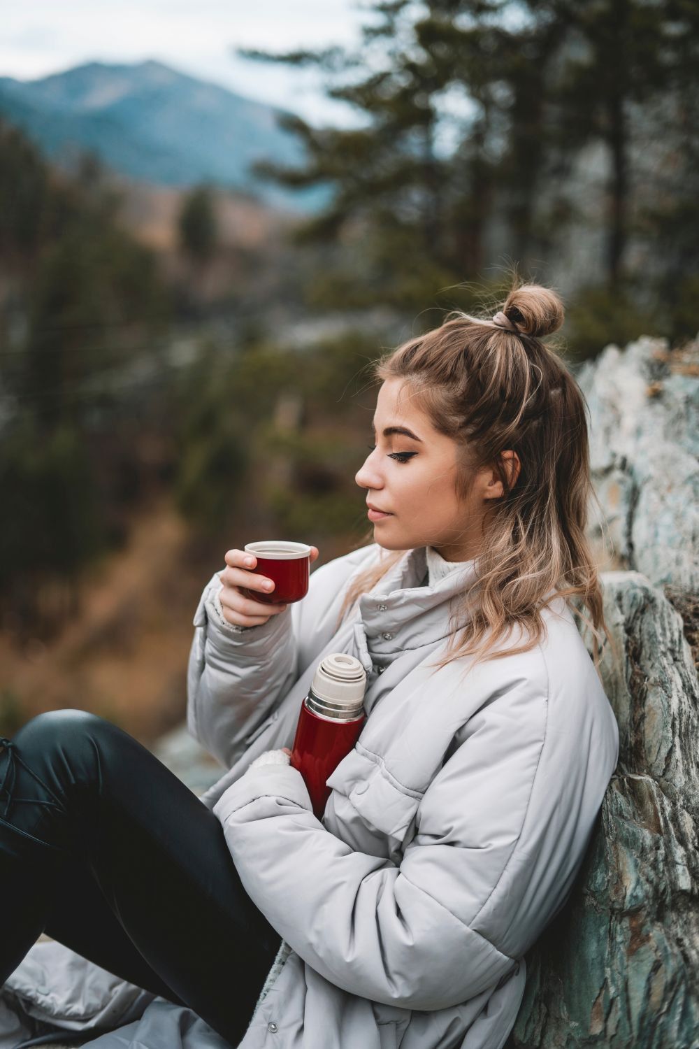 Women taking a break while hiking and drinking Elevation Kick coffee.