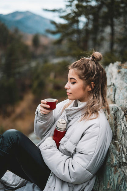 Women taking a break while hiking and drinking Elevation Kick coffee.