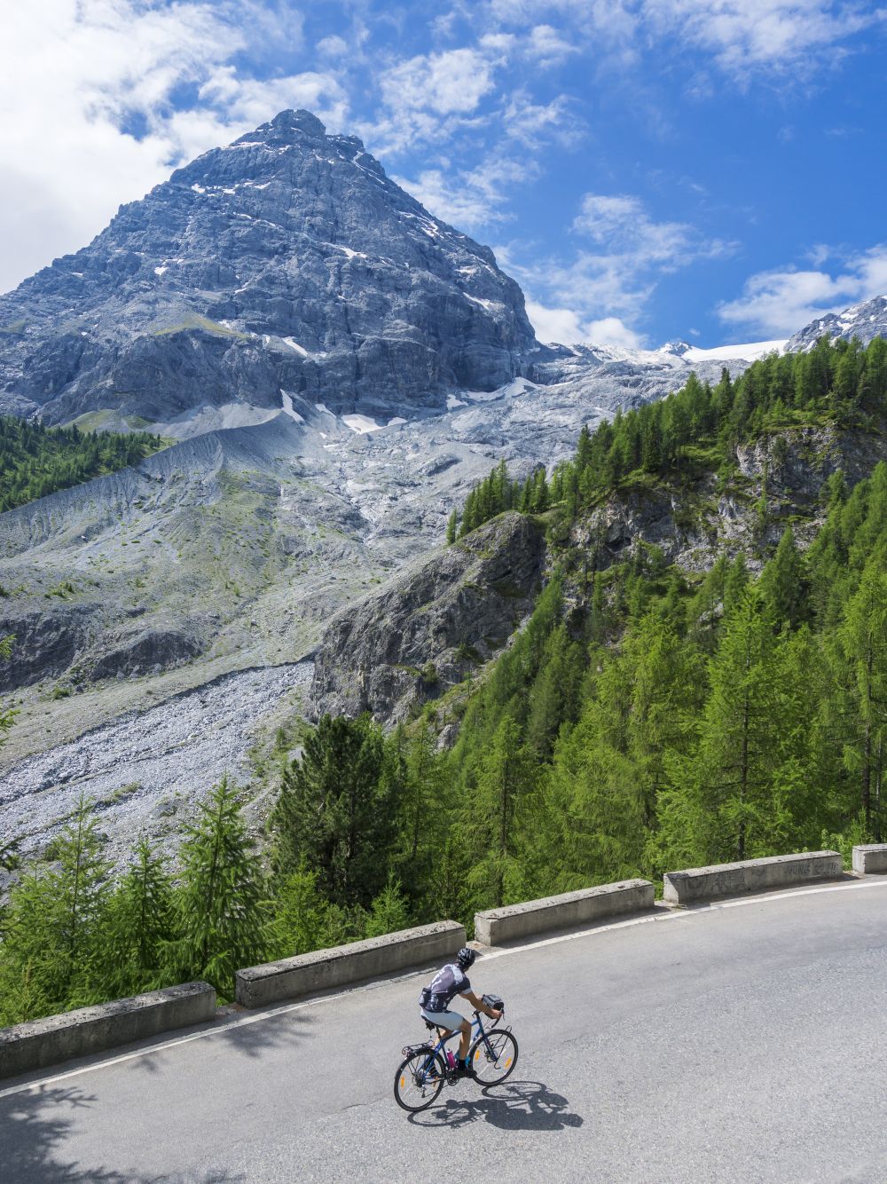 Road biker biking on a road in the mountains
