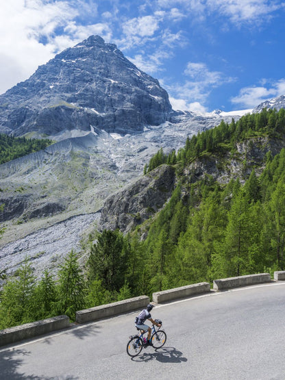 Road biker biking on a road in the mountains