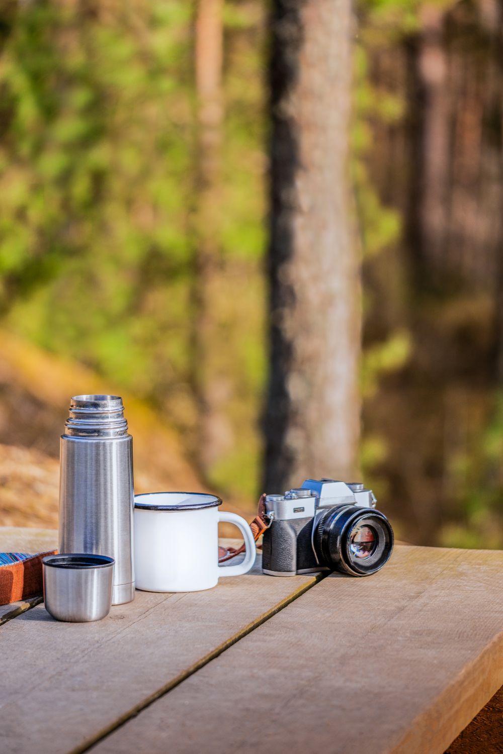 Camping table with coffee and a camera