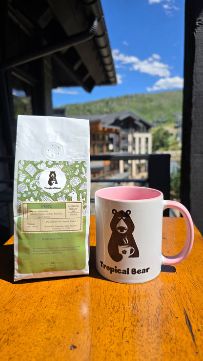 The bag of Peru single-origin organic coffee is next to the tropical bear mug. Fresh good coffee delivered to your door. 