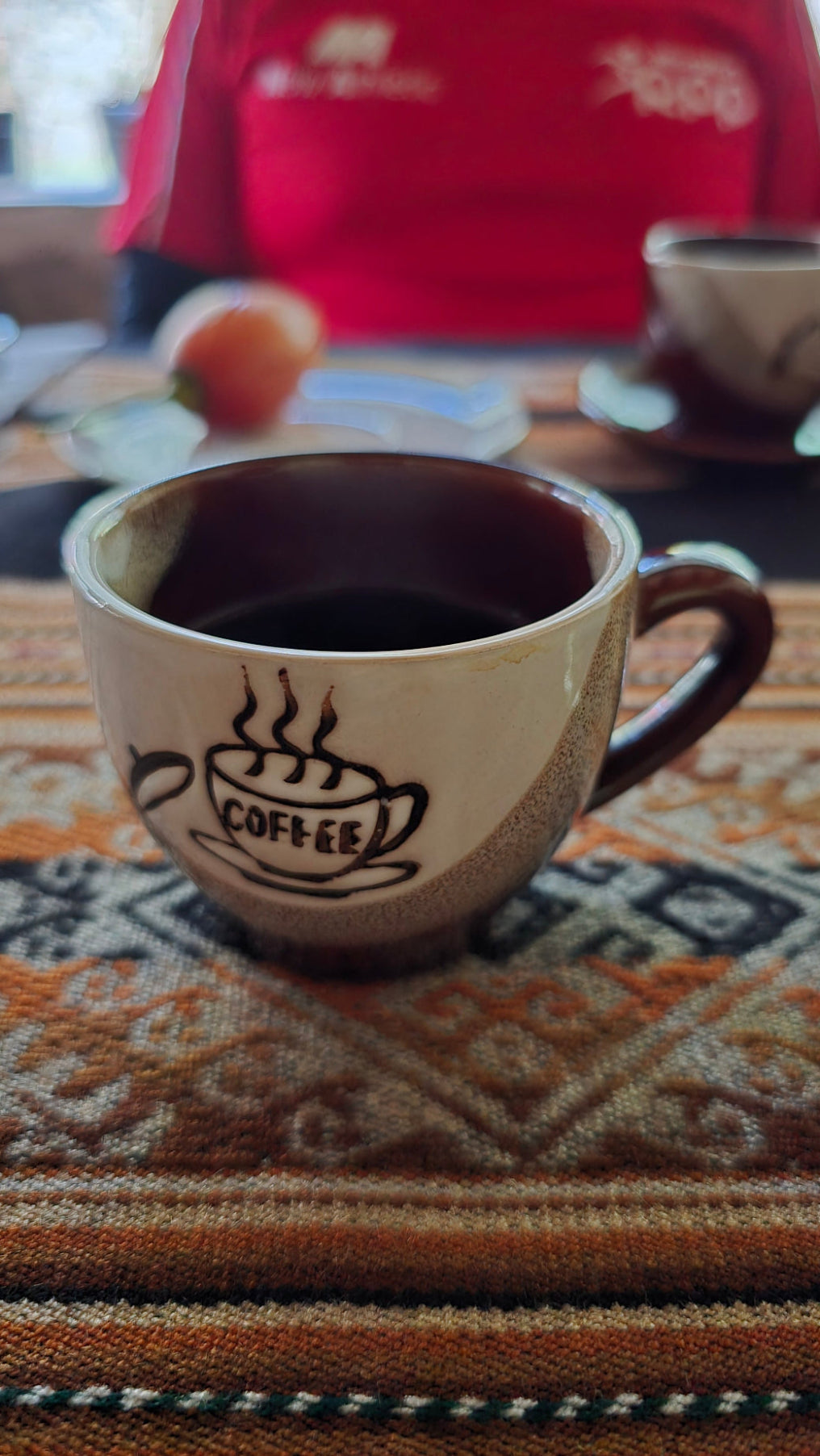 Peru single origin coffee specialty coffee in a mug served by Alejandro on his coffee farm. Tastiest coffee.