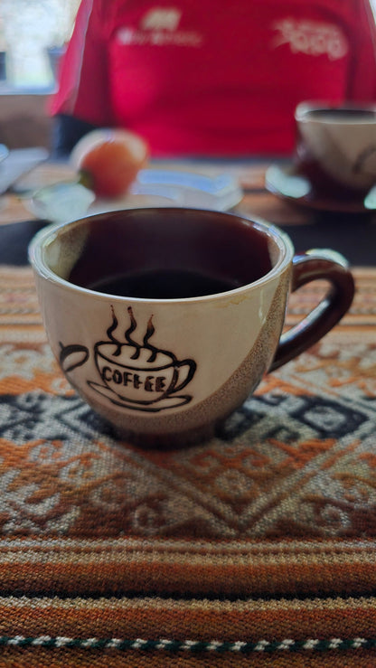 Peru single origin coffee specialty coffee in a mug served by Alejandro on his coffee farm. Tastiest coffee.
