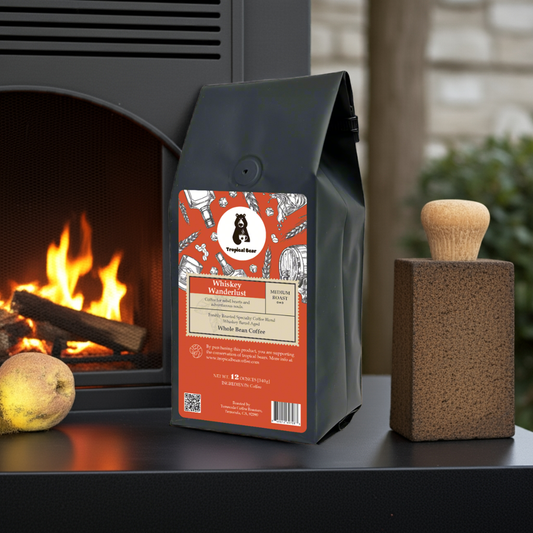 A bag of Whiskey Wanderlust Specialty Coffee placed on a table next to a fireplace. 