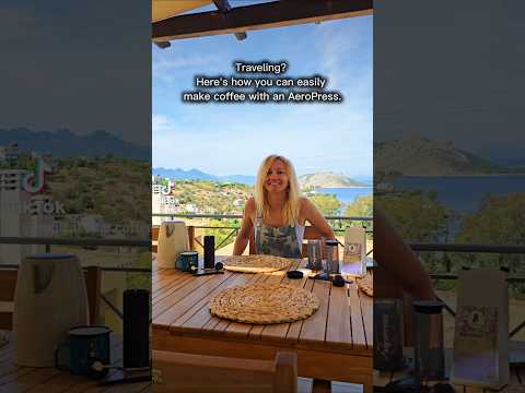 A reel showing Erica Leafe brewing coffee with an Aeropress on a balcony on an island in Greece. 